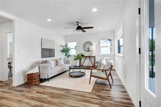 living room featuring recessed lighting, baseboards, and wood finished floors