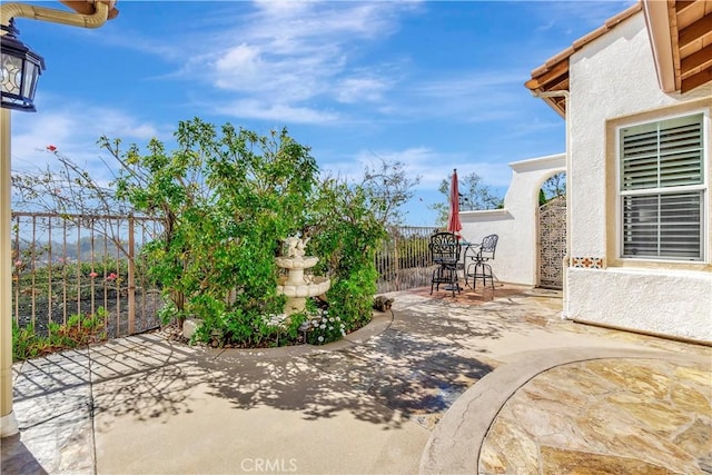 view of patio / terrace featuring fence