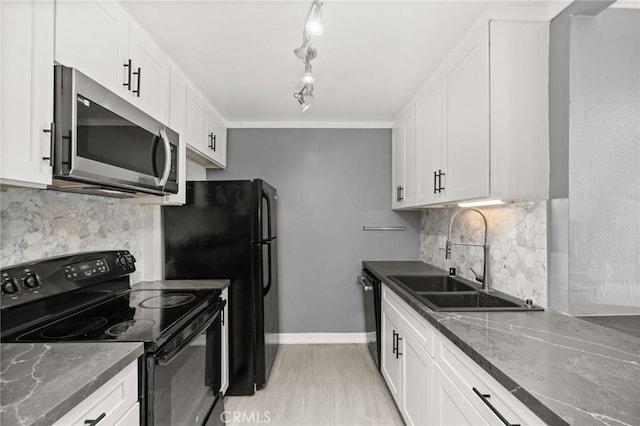 kitchen with black appliances, a sink, white cabinetry, and decorative backsplash