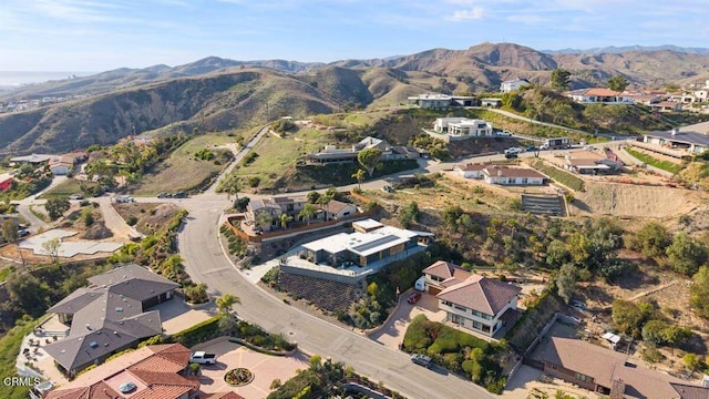 birds eye view of property with a mountain view and a residential view