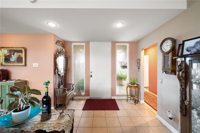 entrance foyer featuring light tile patterned flooring and baseboards