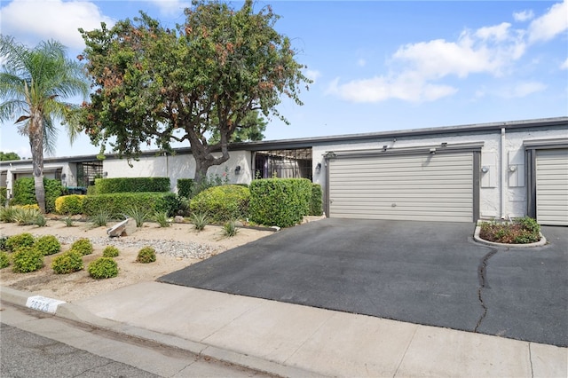 view of front of home featuring aphalt driveway and a garage