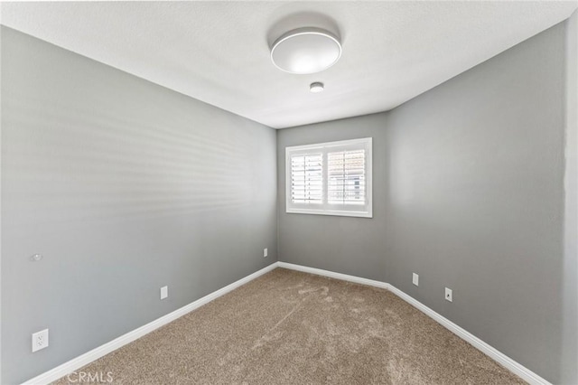 empty room with carpet floors and baseboards