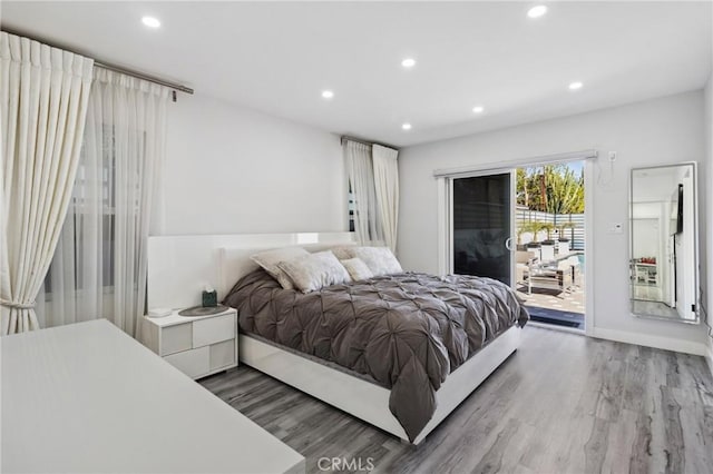 bedroom featuring access to outside, recessed lighting, and wood finished floors