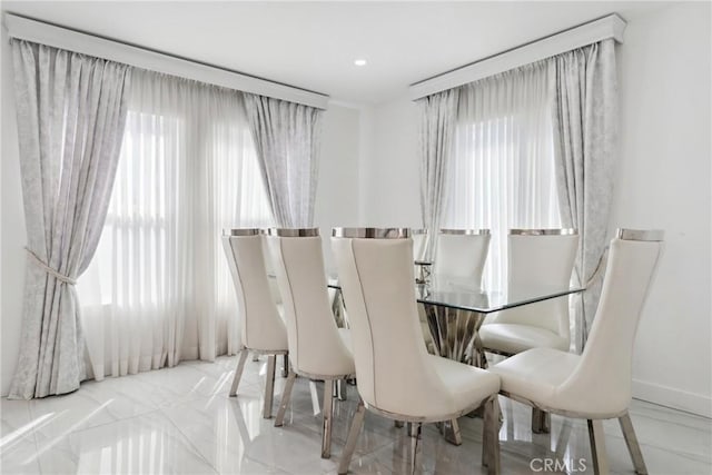 dining area featuring recessed lighting and baseboards