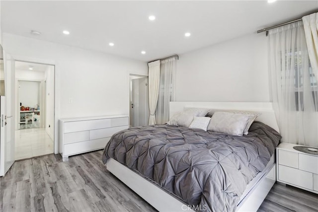 bedroom with light wood-style flooring and recessed lighting