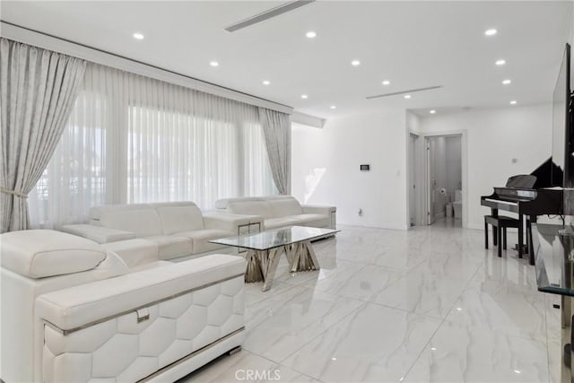 living room featuring marble finish floor and recessed lighting