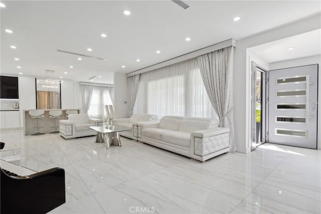 living area with marble finish floor and recessed lighting