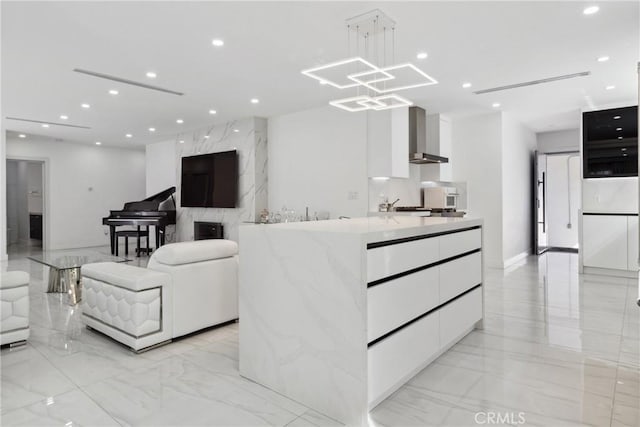 living area with recessed lighting and marble finish floor