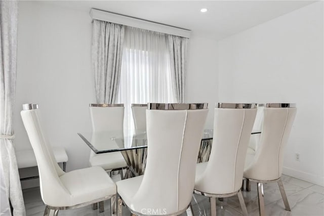 dining area featuring recessed lighting, marble finish floor, and baseboards