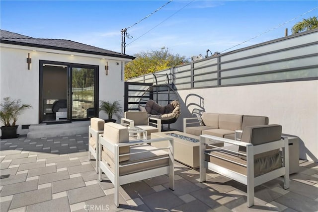 view of patio / terrace featuring an outdoor living space with a fire pit