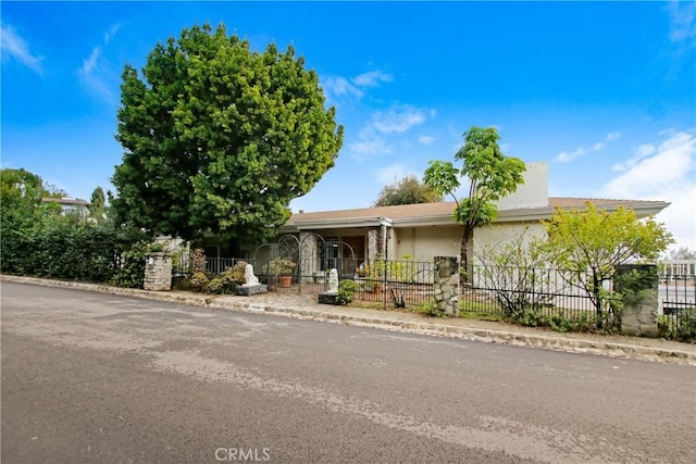 view of front of house featuring a fenced front yard and stucco siding