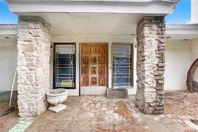 entrance to property featuring stone siding