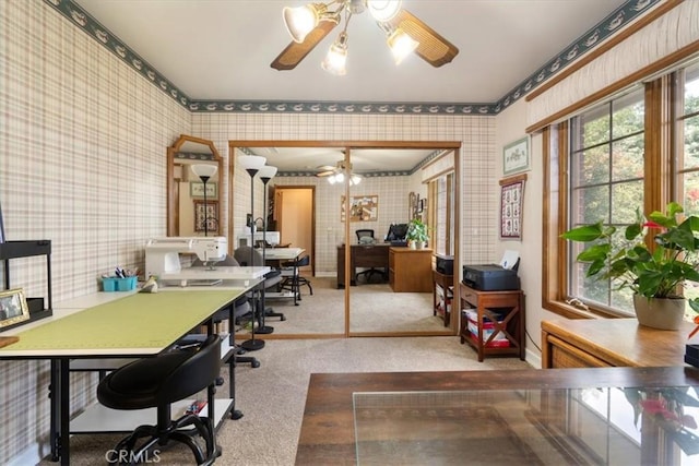 carpeted home office with ceiling fan, baseboards, and wallpapered walls