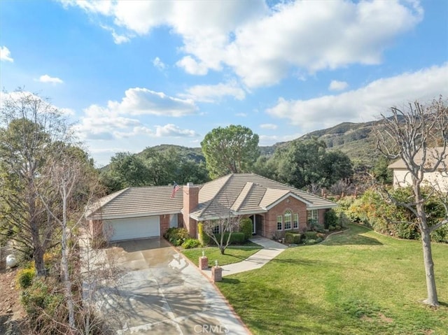 ranch-style house with a garage, a tiled roof, a chimney, and a front yard