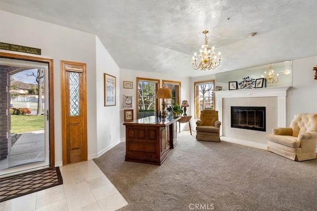 entryway with a fireplace, carpet flooring, vaulted ceiling, a chandelier, and baseboards