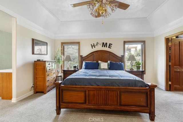 bedroom with multiple windows, baseboards, a raised ceiling, and light colored carpet