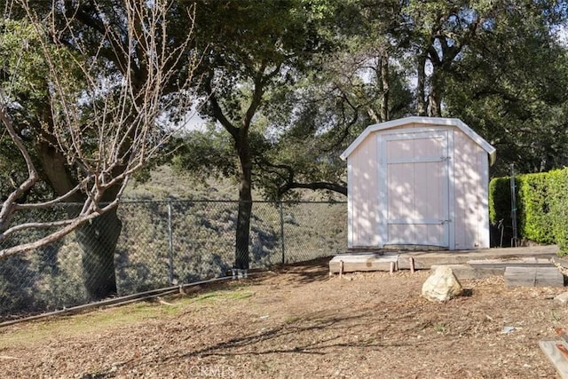 view of shed featuring fence