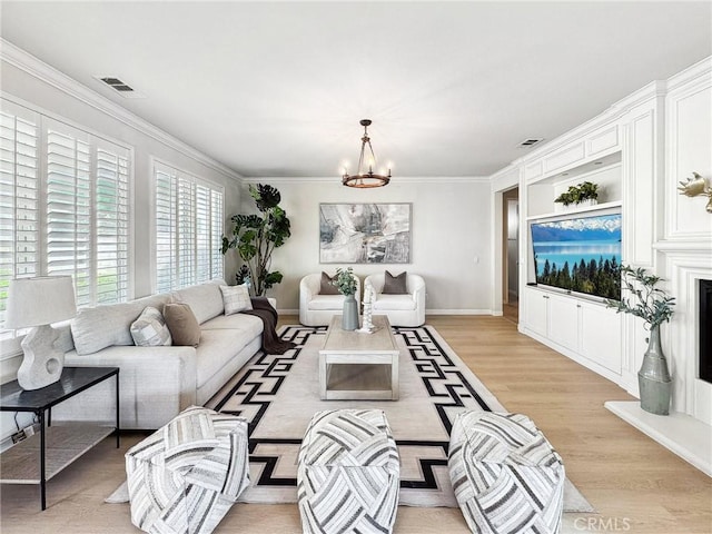 living room featuring light wood finished floors, visible vents, crown molding, and an inviting chandelier