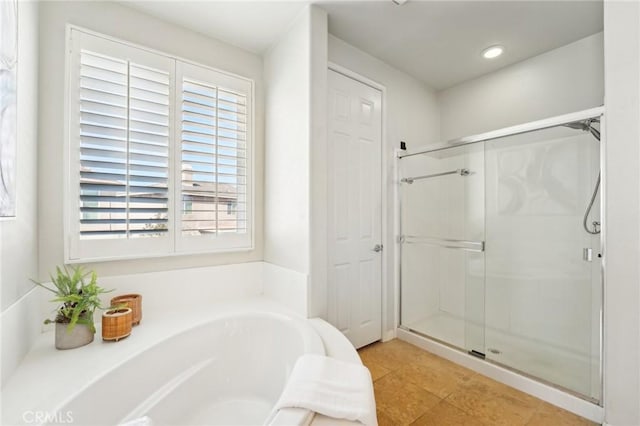 bathroom featuring a stall shower, tile patterned floors, a garden tub, and recessed lighting