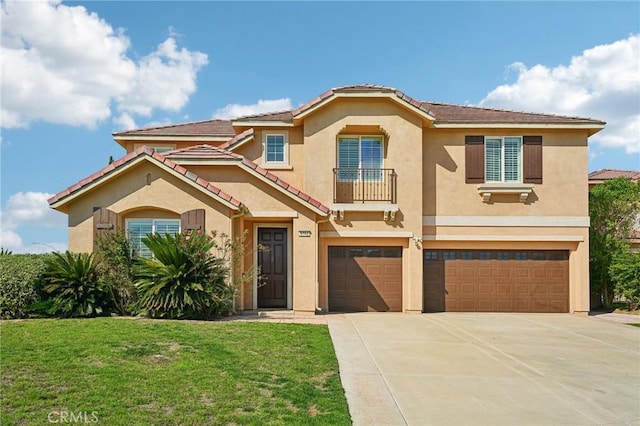 mediterranean / spanish-style home featuring a tile roof, stucco siding, an attached garage, a front yard, and driveway