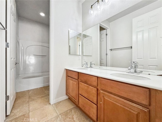 full bathroom featuring a sink, bathing tub / shower combination, baseboards, and double vanity