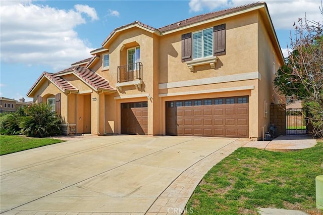 mediterranean / spanish-style home featuring a garage, concrete driveway, a tiled roof, and stucco siding