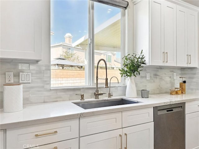 kitchen featuring a sink, light stone counters, white cabinets, and stainless steel dishwasher