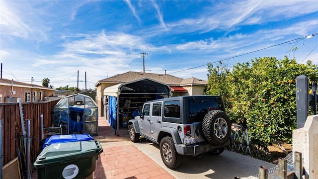 view of parking / parking lot with fence