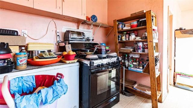 kitchen featuring gas stove and tile patterned floors