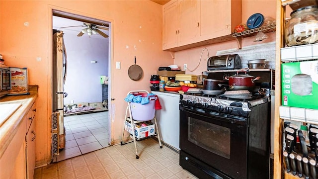 kitchen featuring a toaster, a ceiling fan, light countertops, light floors, and black gas range oven