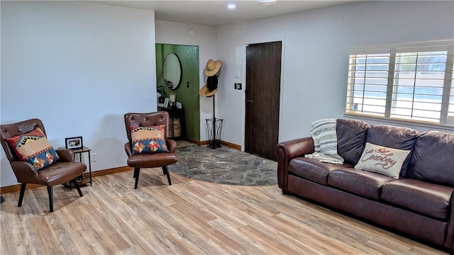 living room featuring baseboards and light wood finished floors