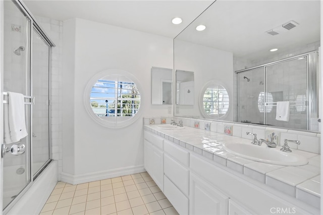 full bath featuring tile patterned flooring, shower / bath combination with glass door, a sink, visible vents, and double vanity