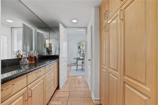 bathroom featuring vanity, stone tile flooring, and recessed lighting