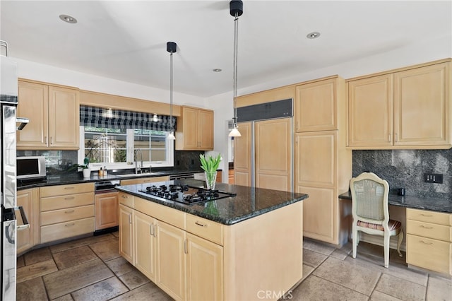 kitchen with decorative light fixtures, black gas cooktop, tasteful backsplash, a kitchen island, and a sink