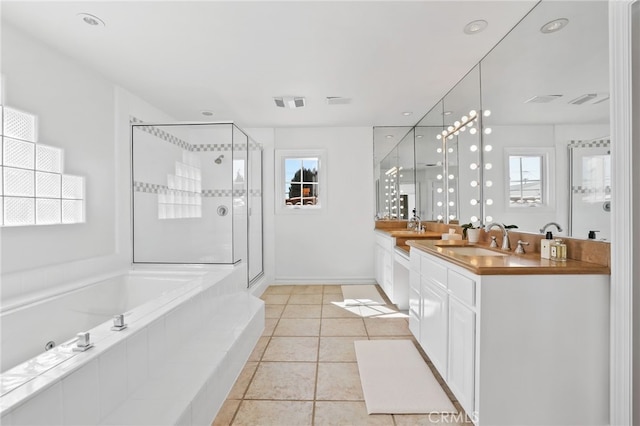 full bathroom with a garden tub, visible vents, a wealth of natural light, and a sink