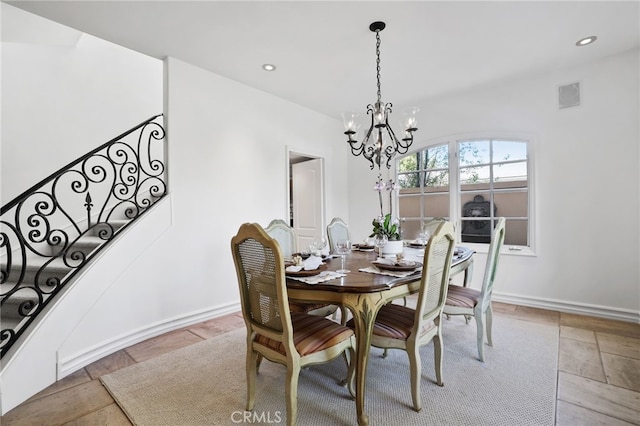 dining area featuring recessed lighting, baseboards, stone tile floors, and stairs