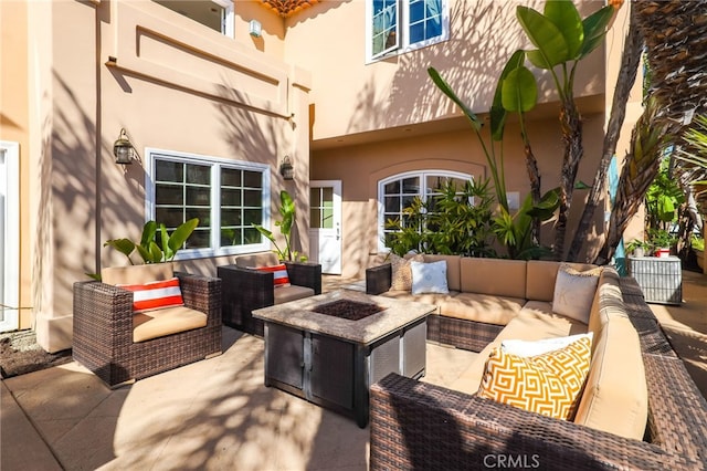 view of patio / terrace with an outdoor living space with a fire pit