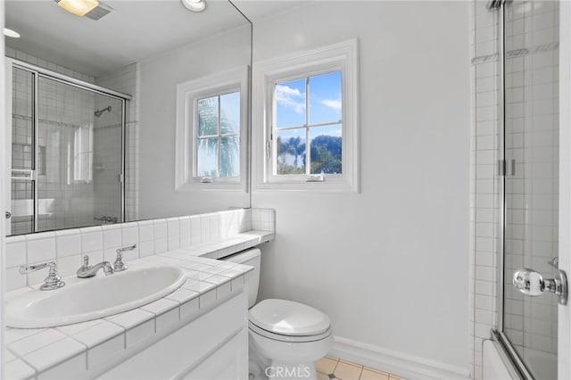 bathroom featuring toilet, baseboards, bath / shower combo with glass door, and vanity