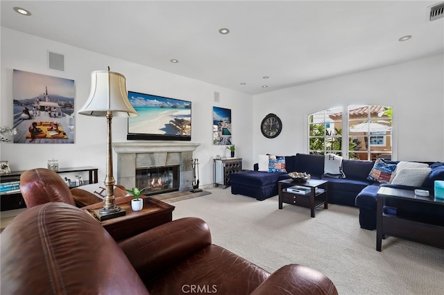 living area with a premium fireplace, carpet, visible vents, and recessed lighting