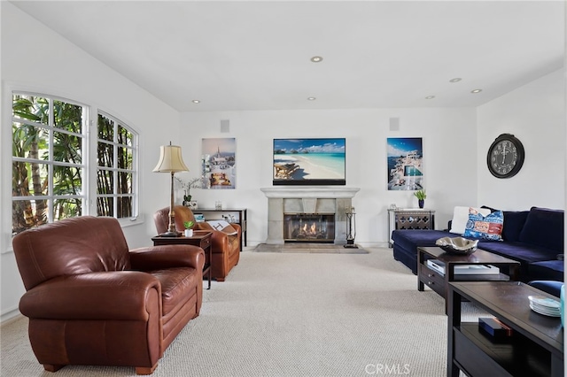 living area featuring recessed lighting, light colored carpet, and a tiled fireplace