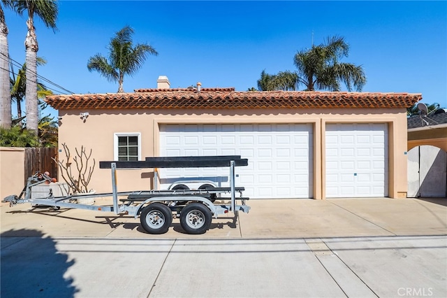 exterior space featuring a tiled roof, an outbuilding, and stucco siding