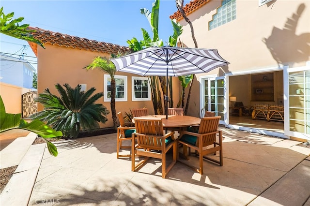 view of patio with outdoor dining space and french doors