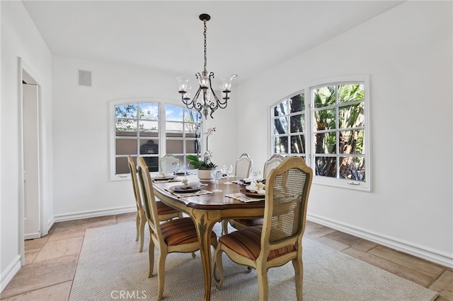 dining space with baseboards, visible vents, and a notable chandelier