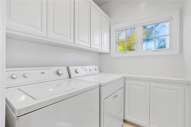 washroom with cabinet space and independent washer and dryer