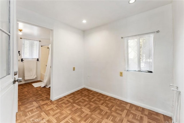 unfurnished room with recessed lighting, a wealth of natural light, and baseboards