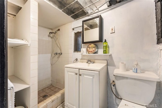 full bathroom featuring a stall shower, vanity, and toilet