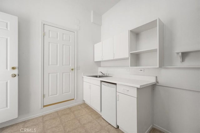 kitchen with open shelves, light countertops, white cabinets, white dishwasher, and a sink