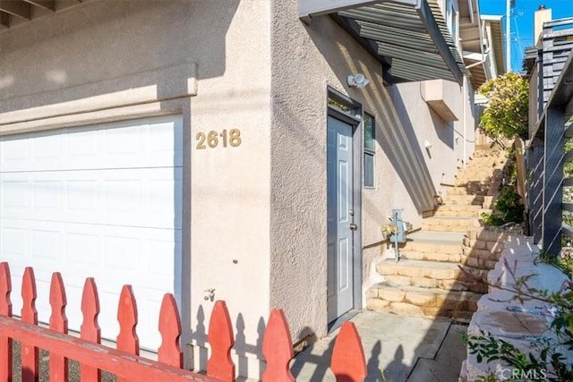 view of exterior entry with stucco siding