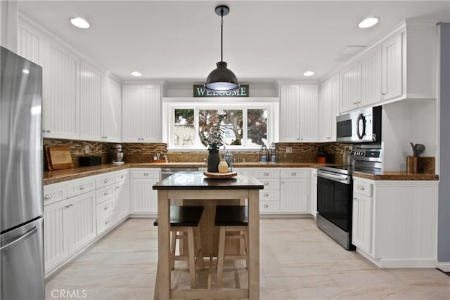 kitchen featuring appliances with stainless steel finishes, recessed lighting, white cabinetry, and tasteful backsplash